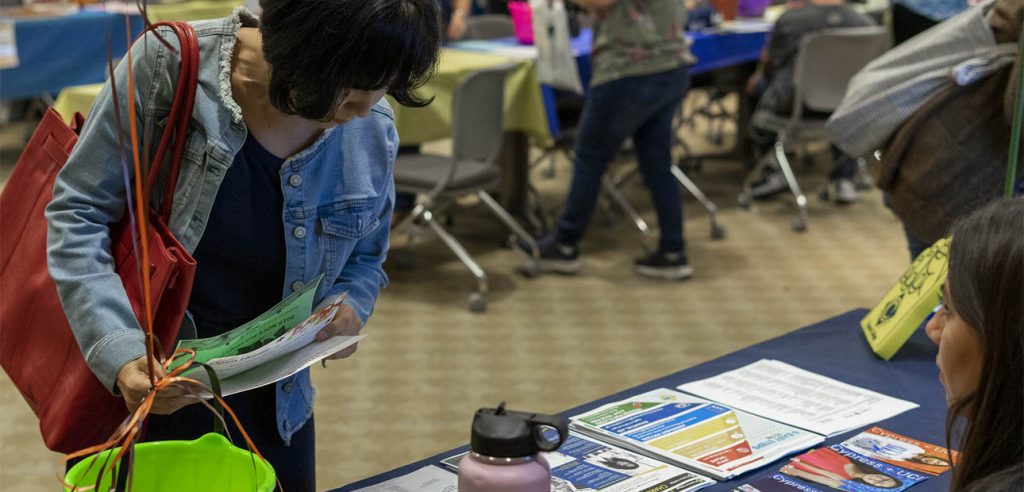 Student looking at fliers at a resource event