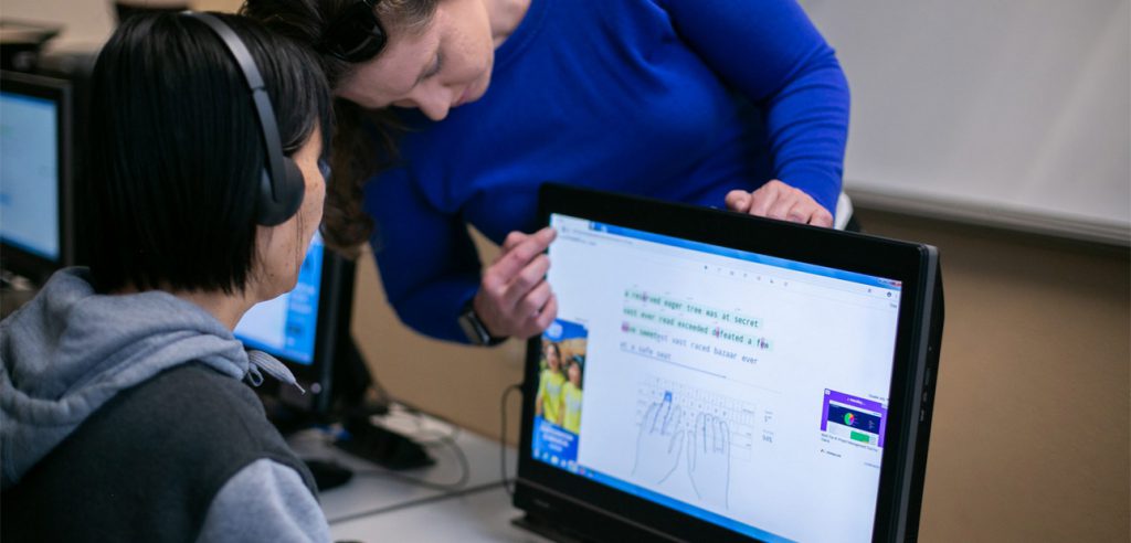 DSS Instructor Helping DSS student at the computer