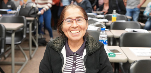 A smiling ESL student in class