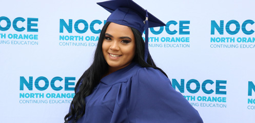 High school diploma graduate posing for a picture