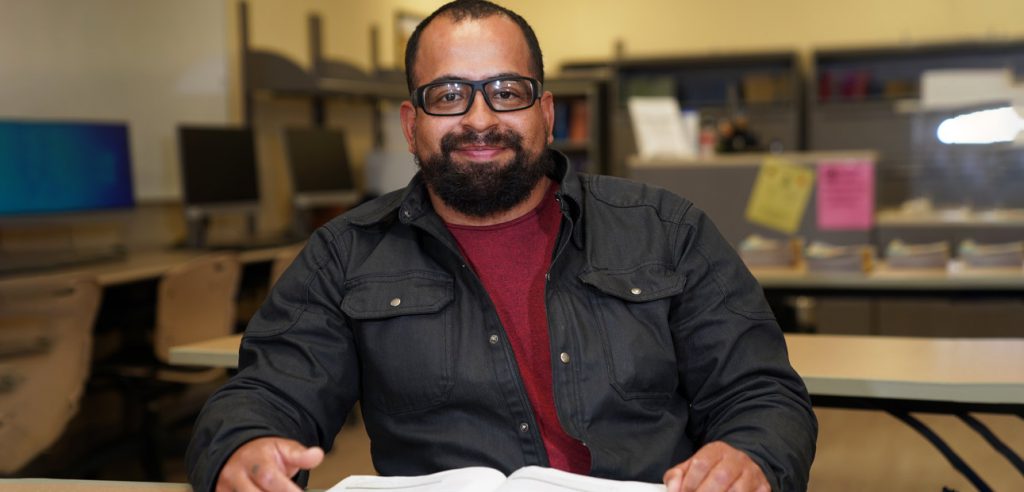 A smiling high school diploma attending the Anaheim campus high school lab