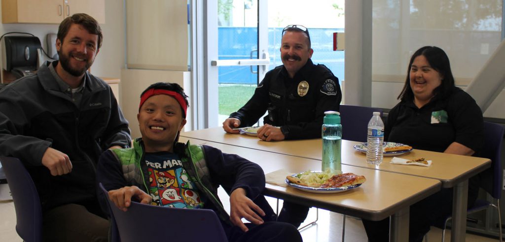 An event image of disability support services students with their instructor and a city of cypress police officer. 