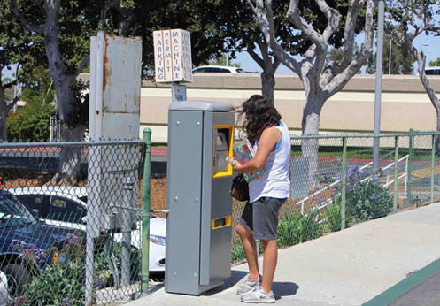 A student buying a one-day parking permit at one of the Anaheim Campus kiosks.