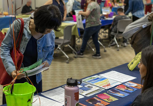 Student looking at fliers at a resource event