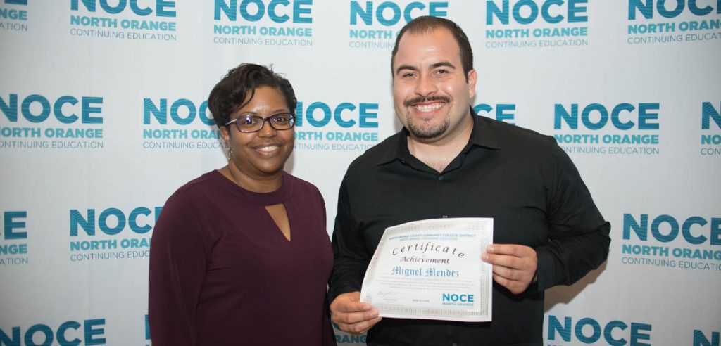 Student and teacher taking an award photo together.