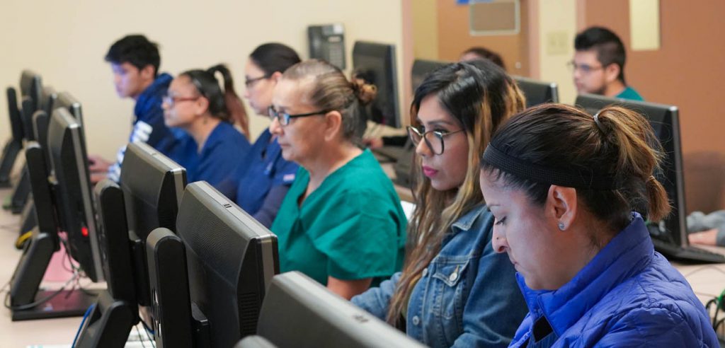 A photo of a row of CTE students at their computers.