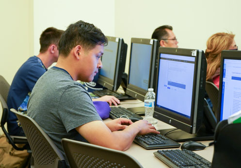 A NOCE student working on the computer.