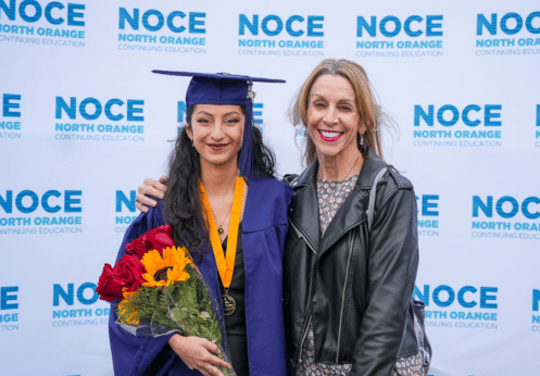 A High School Diploma Program student posing with the High School Lab teacher during the 2023 Commencement event.