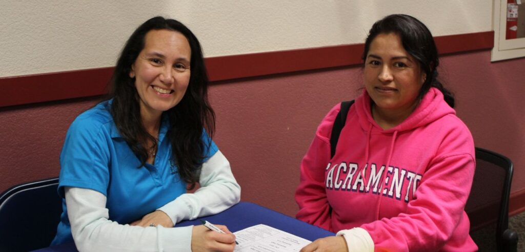 A NOCE counselor and a student smiling for the camera