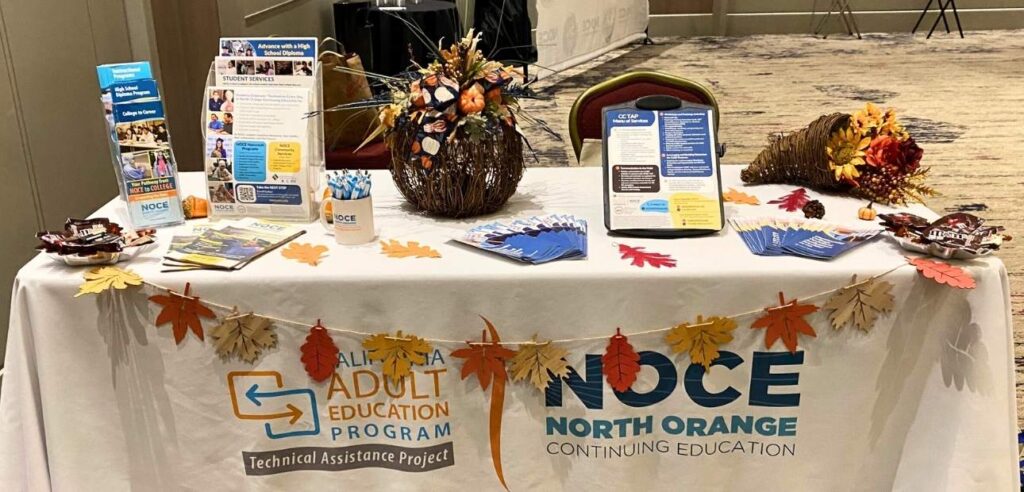 NOCE CC TAP Fall Outreach table set up with the white NOCE and CC Tap tablecloth