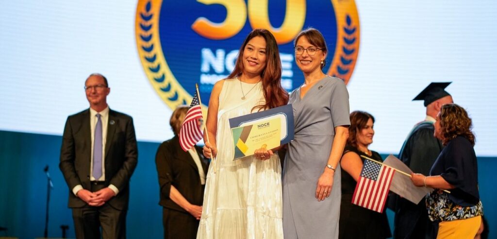 A photo of an ESL Citizenship Program student receiving their certificate and posing for a photo with NOCE President Valentina Purtell.