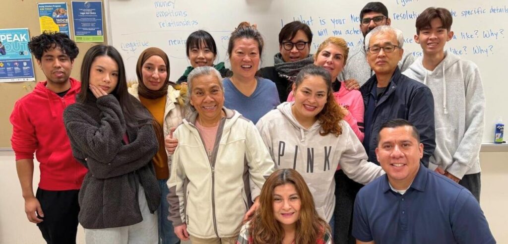 NOCE’s 2026 Teacher of the Year Nominee, Helen Serrano posing in a class group photo.