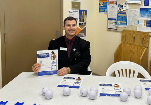 A photo of Robert Johnson at the outreach table promoting mental health resources to students at NOCE.