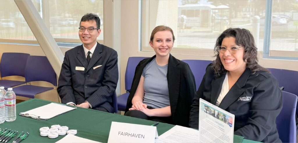Fairhaven representatives providing information at an outreach table.