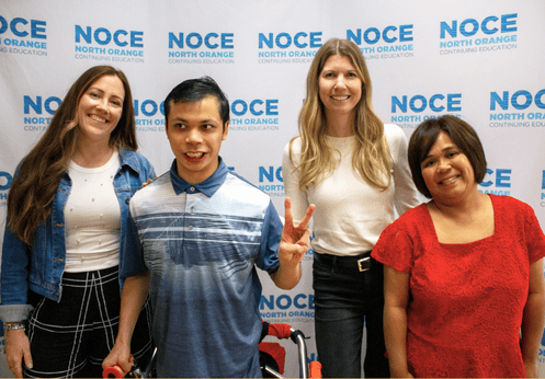 DSS Teacher and Counselor posing with students for a photo