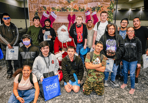 A group of DSS students posing with Santa Claus at the December 2025 Power Up Resource Fair