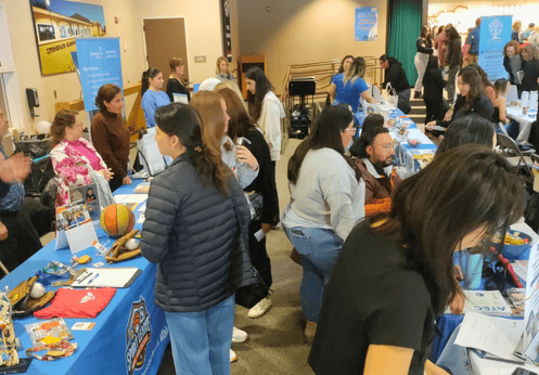 Resource tables and activities during the 2025 Disability Support Services Transition Night event.