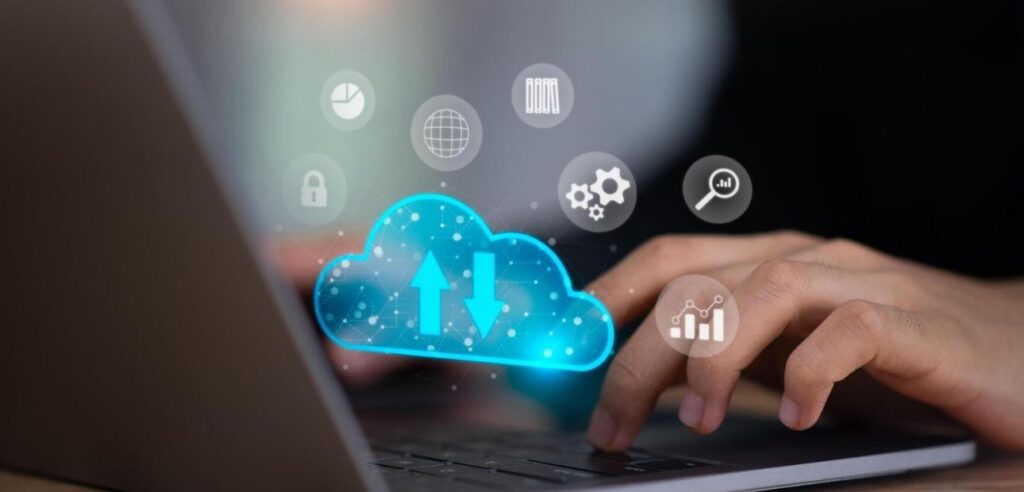 A graphic with a person typing and a digital cloud layered over the image.